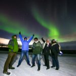 Group photo under the dancing Northern Light